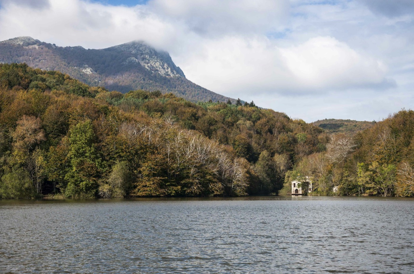 The lake of Santa Fe del Montseny, autumn forest and the Tur&oacute; de l'Home behind