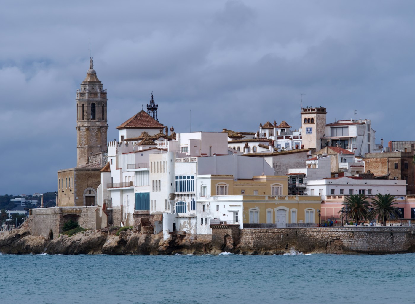 Sitges from the sea: the church of Sant Bartomeu i Santa Tecla and the white houses on the rocks