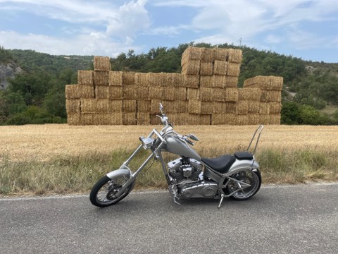 Cruiser parked beside stacked hay bales on the Spanish side of the Pyrenees